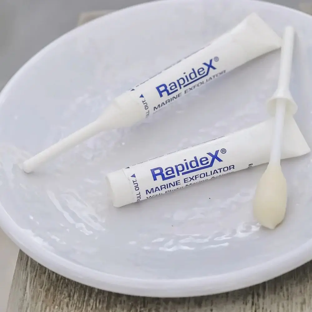 Woman applying Repêchage Rapidex Marine Exfoliator with cotton swab – easy at-home peel.