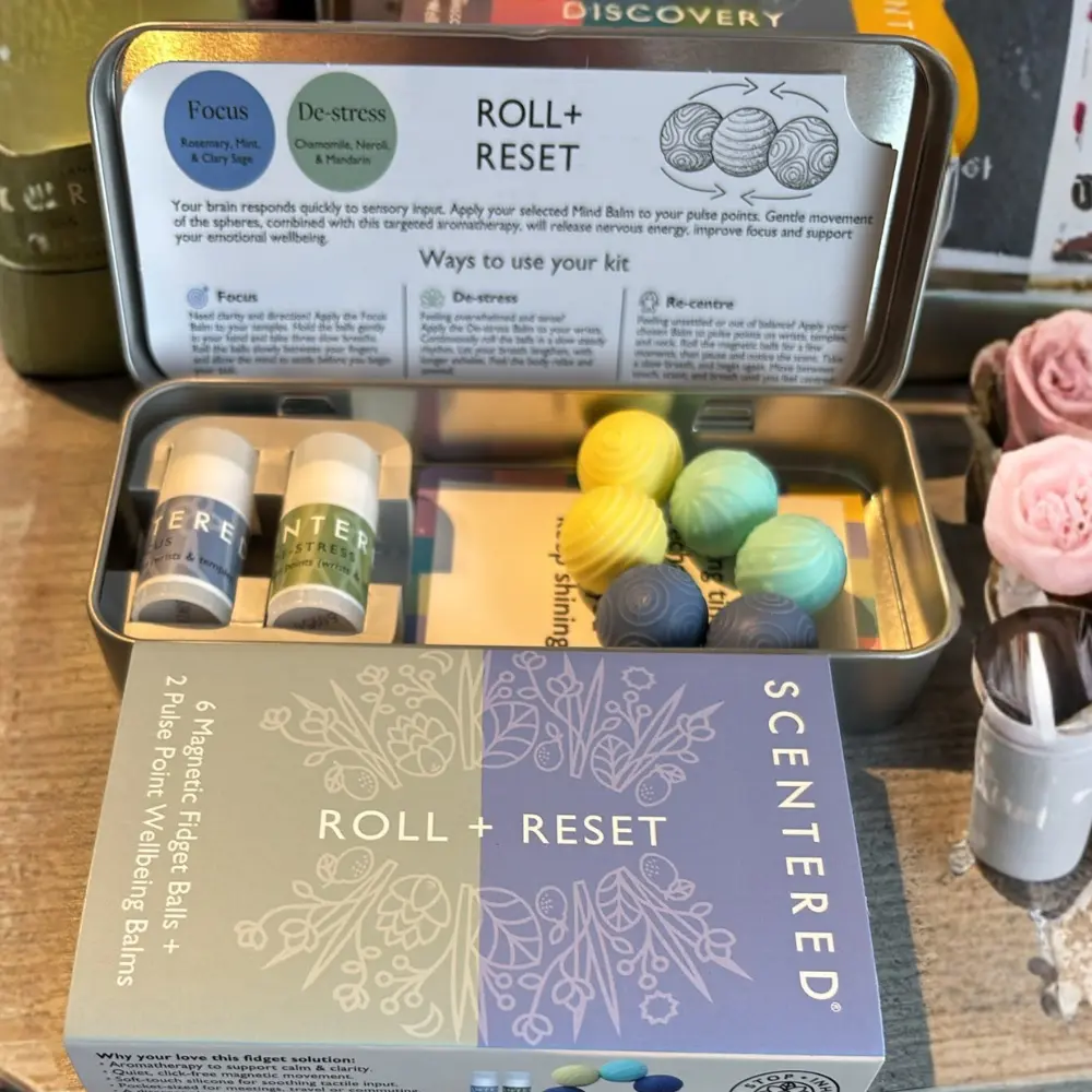 Open Scentered Roll & Reset travel tin with six textured fidget balls and two aromatherapy balms