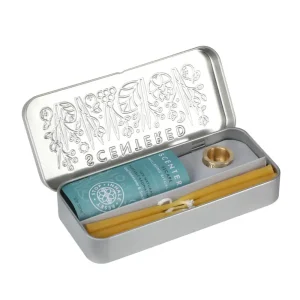 Scentered Press Pause Set showing natural beeswax candles, brass candle holder and Escape Aromatherapy Balm in an embossed silver tin.